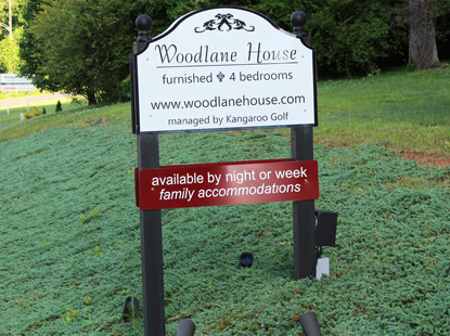 Sign in front of Woodlane House, the rental house that can be reserved on a nightly or weekly basis.